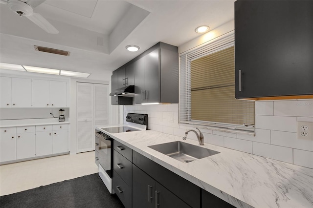 3140 Village Green Dr Unit 1119, Sarasota, FL 34239 - kitchen with dark cabinets, under cabinet range hood, visible vents, range with electric cooktop, and a sink