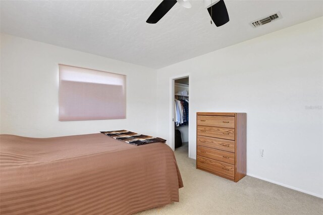 3140 Village Green Dr Unit 1119, Sarasota, FL 34239 - bedroom featuring a closet, a ceiling fan, visible vents, light carpet, and a walk in closet
