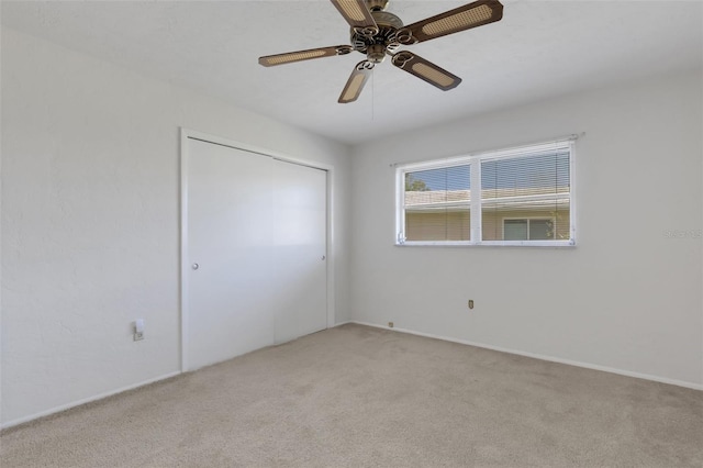 3140 Village Green Dr Unit 1119, Sarasota, FL 34239 - unfurnished bedroom featuring light carpet, a closet, ceiling fan, and baseboards