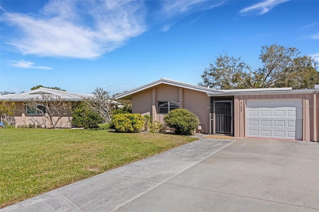 3140 Village Green Dr Unit 1119, Sarasota, FL 34239 - single story home featuring a front lawn, stucco siding, an attached garage, and concrete driveway