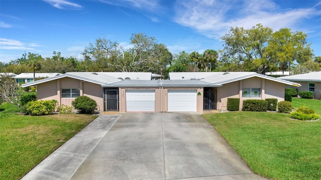 3140 Village Green Dr Unit 1119, Sarasota, FL 34239 - ranch-style house with a garage, a front yard, concrete driveway, and stucco siding