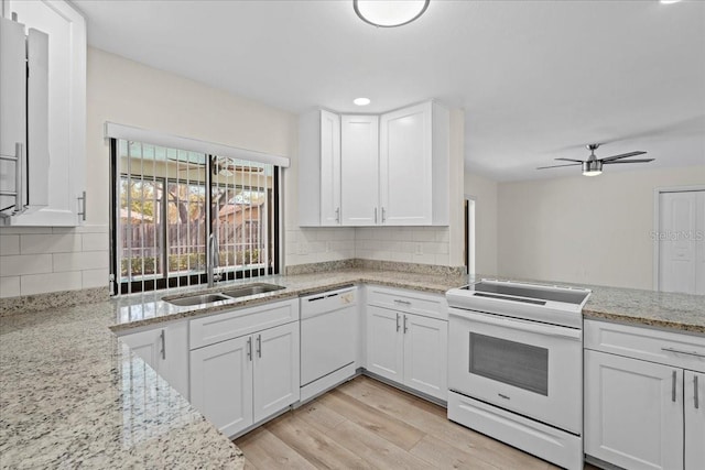 kitchen featuring white appliances, white cabinets, light wood-style flooring, and a sink