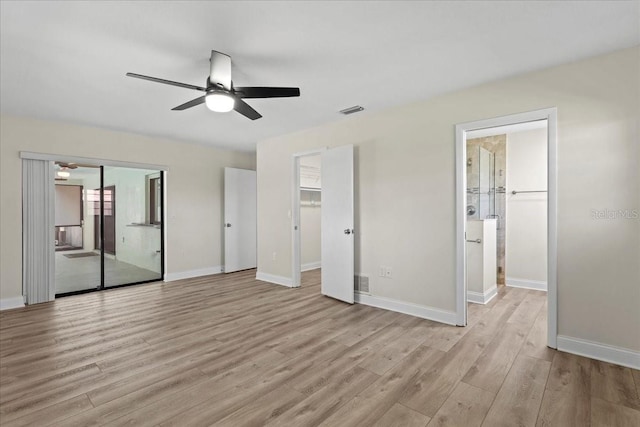 unfurnished bedroom featuring light wood-style flooring, baseboards, and visible vents