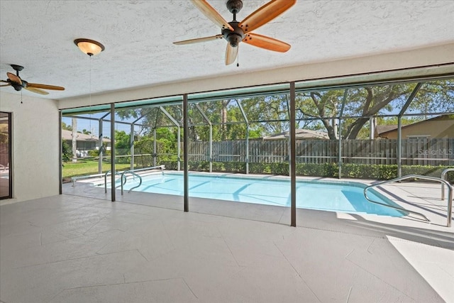 view of swimming pool with a lanai, fence, a fenced in pool, and a patio