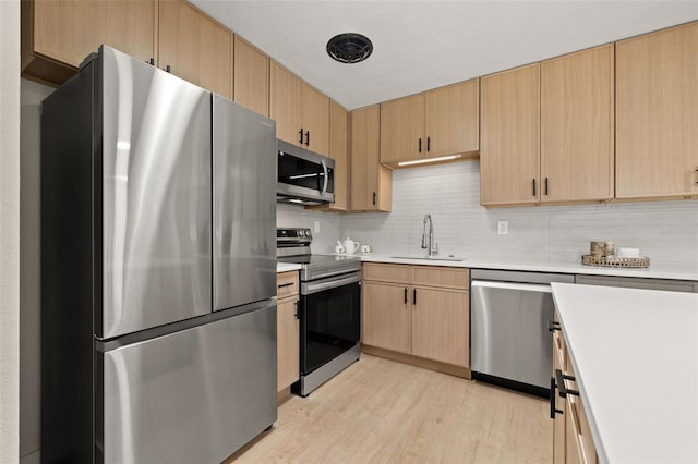 6639 16th St N, Saint Petersburg, FL 33702 - kitchen featuring light brown cabinets, stainless steel appliances, light countertops, and a sink
