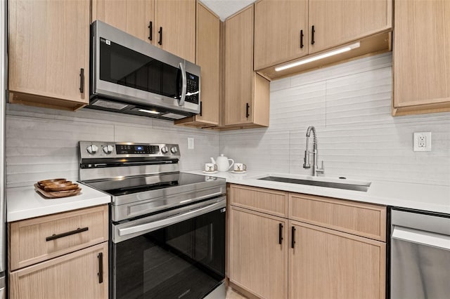 6639 16th St N, Saint Petersburg, FL 33702 - kitchen with a sink, stainless steel appliances, light brown cabinets, and light countertops