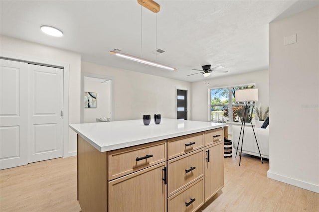 6639 16th St N, Saint Petersburg, FL 33702 - kitchen with light countertops, light wood finished floors, and a center island