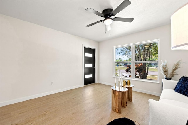 6639 16th St N, Saint Petersburg, FL 33702 - living room featuring light wood finished floors, a ceiling fan, and baseboards