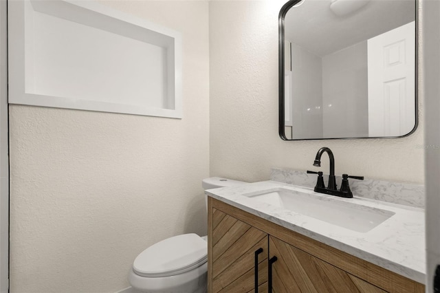 6639 16th St N, Saint Petersburg, FL 33702 - half bathroom featuring toilet, vanity, and a textured wall