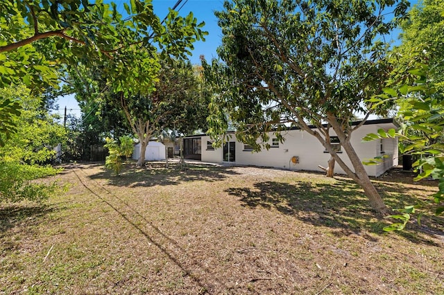 6639 16th St N, Saint Petersburg, FL 33702 - view of yard featuring an outdoor structure and a storage unit