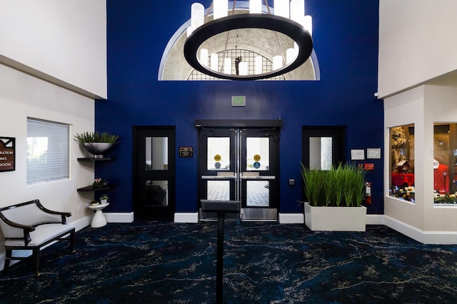 9408 Glen Abbey Ln, Sarasota, FL 34238 - carpeted foyer featuring a high ceiling and baseboards