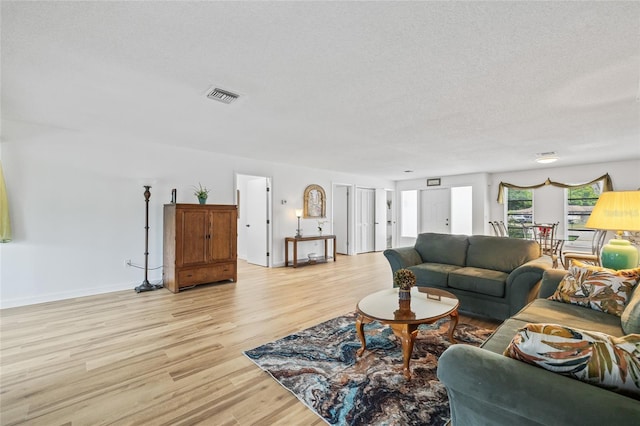 3611 22nd Ave W, Bradenton, FL 34205 - living room with light wood finished floors and a textured ceiling