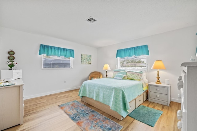 3611 22nd Ave W, Bradenton, FL 34205 - bedroom with multiple windows and light wood-style flooring