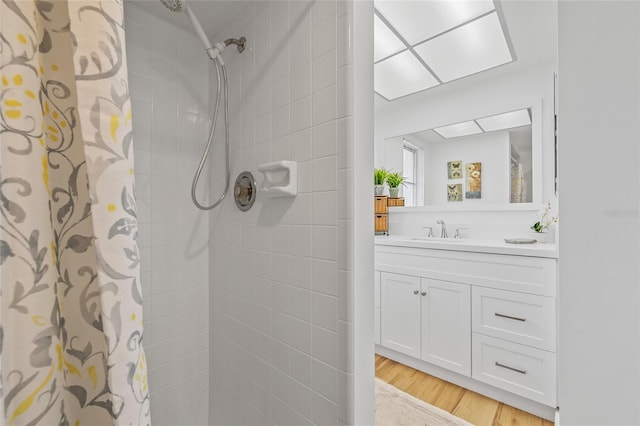3611 22nd Ave W, Bradenton, FL 34205 - bathroom with tiled shower, vanity, and wood finished floors