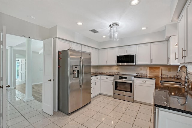 kitchen with a sink, visible vents, ornate columns, and stainless steel appliances