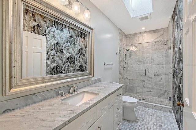 full bath featuring a shower stall, toilet, a skylight, tile patterned floors, and vanity