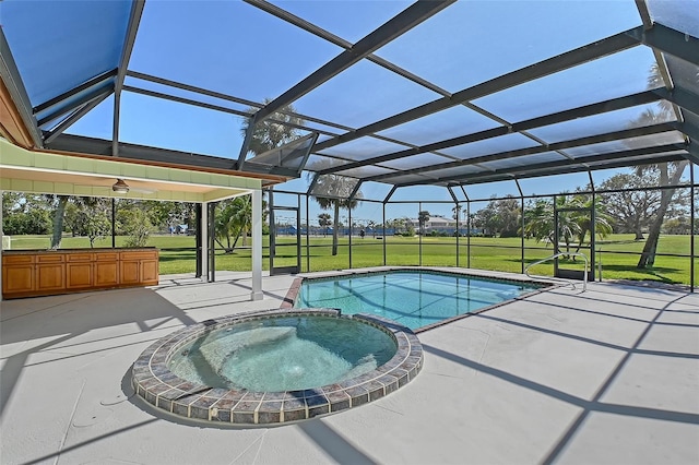 view of swimming pool with glass enclosure, a patio, a lawn, and a pool with connected hot tub