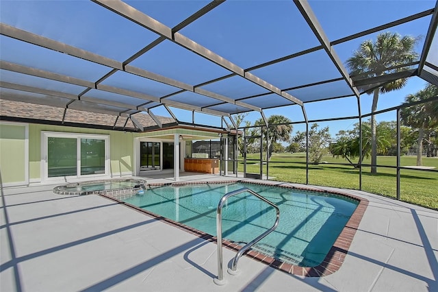 view of pool with a lanai, a yard, a pool with connected hot tub, and a patio