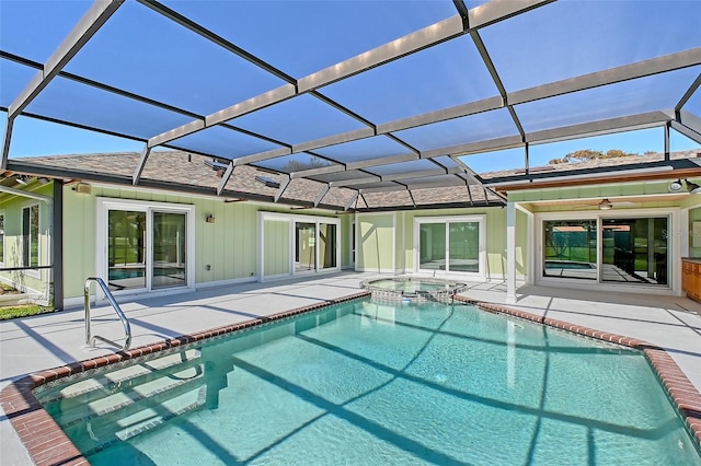 view of pool featuring a patio, a ceiling fan, a pool with connected hot tub, and a lanai