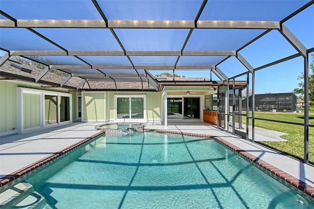 view of swimming pool with a patio, a lawn, a lanai, and a pool with connected hot tub
