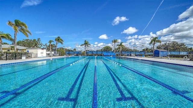 view of swimming pool with fence