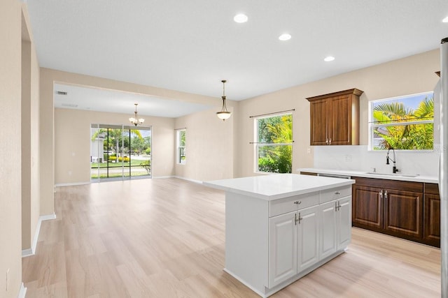 11790 Fennemore Way, Parrish, FL 34219 - kitchen with recessed lighting, a sink, a center island, and light countertops