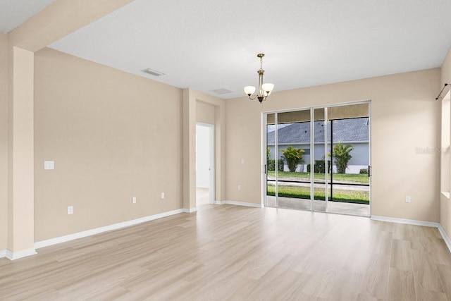 11790 Fennemore Way, Parrish, FL 34219 - unfurnished room with baseboards, a chandelier, light wood-style flooring, and visible vents