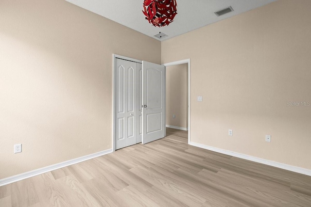 11790 Fennemore Way, Parrish, FL 34219 - unfurnished bedroom with light wood-style floors, baseboards, and visible vents