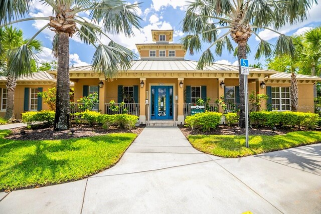 11790 Fennemore Way, Parrish, FL 34219 - view of front of home with covered porch, a standing seam roof, metal roof, and stucco siding