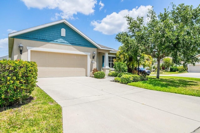11790 Fennemore Way, Parrish, FL 34219 - view of front of house featuring an attached garage, stucco siding, driveway, and a front yard