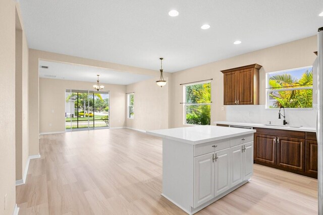 11790 Fennemore Way, Parrish, FL 34219 - kitchen with recessed lighting, a sink, a center island, and light countertops