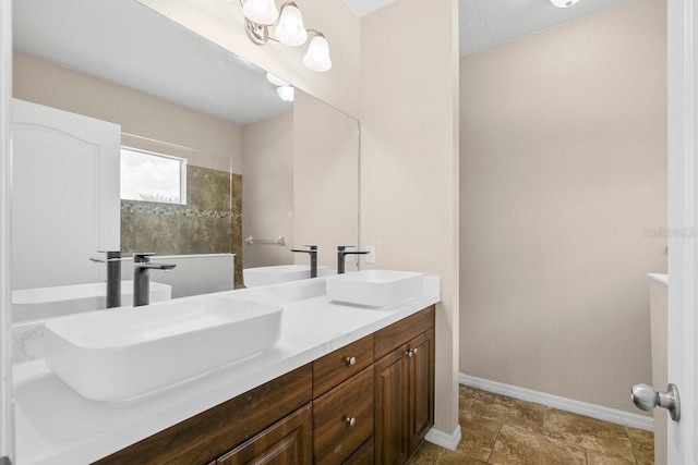 11790 Fennemore Way, Parrish, FL 34219 - bathroom featuring double vanity, baseboards, and a sink