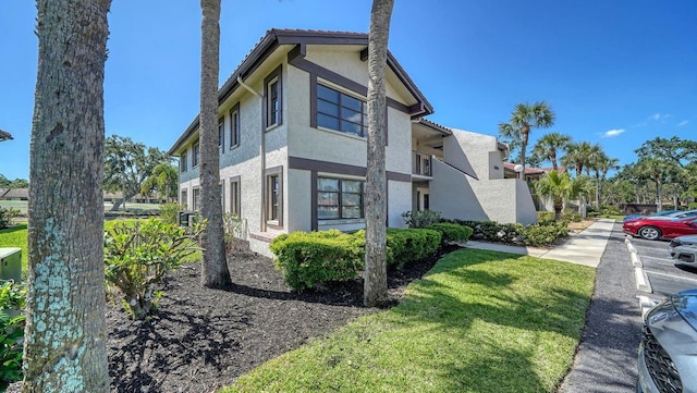 5630 Golf Pointe Dr Unit 205, Sarasota, FL 34243 - view of property exterior with stucco siding and a tile roof