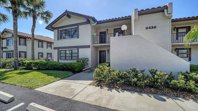 5630 Golf Pointe Dr Unit 205, Sarasota, FL 34243 - view of front of house featuring stucco siding and a tile roof
