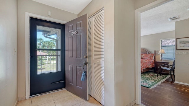 5630 Golf Pointe Dr Unit 205, Sarasota, FL 34243 - doorway with baseboards and visible vents
