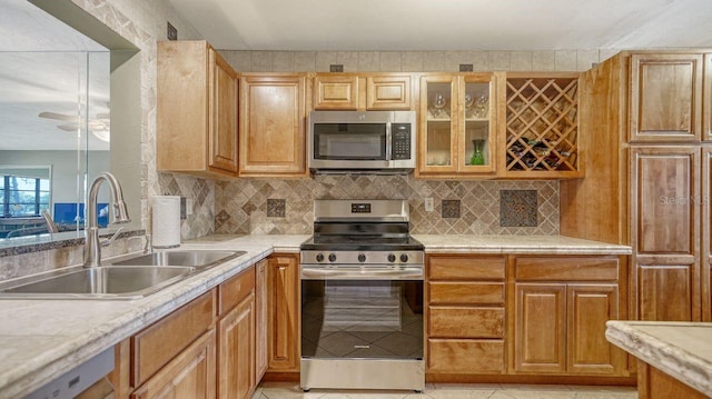 5630 Golf Pointe Dr Unit 205, Sarasota, FL 34243 - kitchen with a sink, glass insert cabinets, light countertops, and appliances with stainless steel finishes