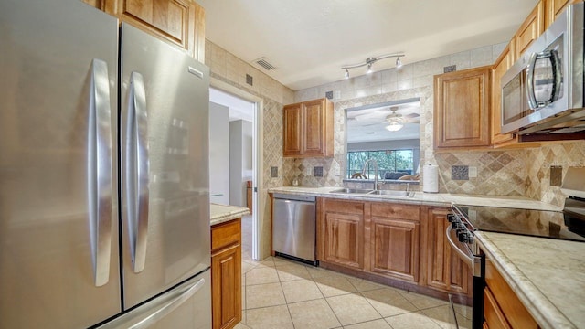 5630 Golf Pointe Dr Unit 205, Sarasota, FL 34243 - kitchen with visible vents, a sink, light countertops, ceiling fan, and stainless steel appliances