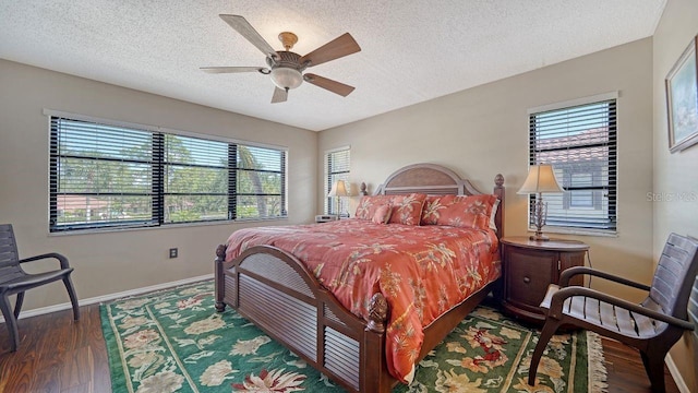 5630 Golf Pointe Dr Unit 205, Sarasota, FL 34243 - bedroom with a textured ceiling, wood finished floors, baseboards, and a ceiling fan