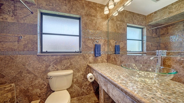 5630 Golf Pointe Dr Unit 205, Sarasota, FL 34243 - bathroom featuring toilet, vanity, and tile walls