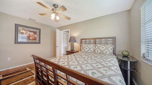 5630 Golf Pointe Dr Unit 205, Sarasota, FL 34243 - bedroom with visible vents, baseboards, a ceiling fan, and wood finished floors