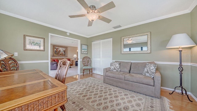 5630 Golf Pointe Dr Unit 205, Sarasota, FL 34243 - office area featuring visible vents, baseboards, ornamental molding, light wood-type flooring, and a ceiling fan