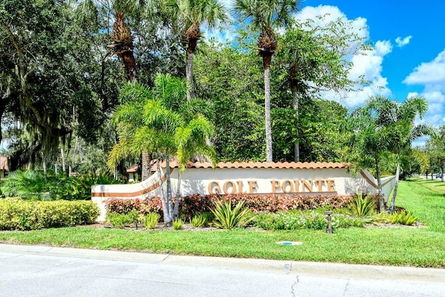 5630 Golf Pointe Dr Unit 205, Sarasota, FL 34243 - community / neighborhood sign featuring a lawn
