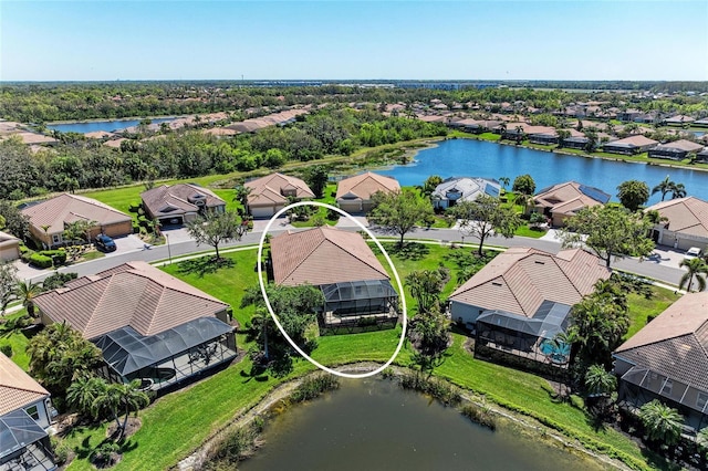 drone / aerial view with a residential view and a water view