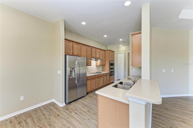 kitchen with stainless steel fridge with ice dispenser, a peninsula, light wood-style floors, black electric cooktop, and a sink