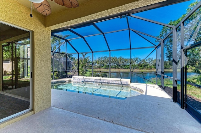 outdoor pool featuring a patio, a ceiling fan, a water view, and a lanai