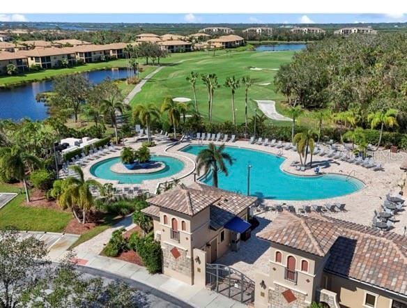 birds eye view of property featuring golf course view and a water view