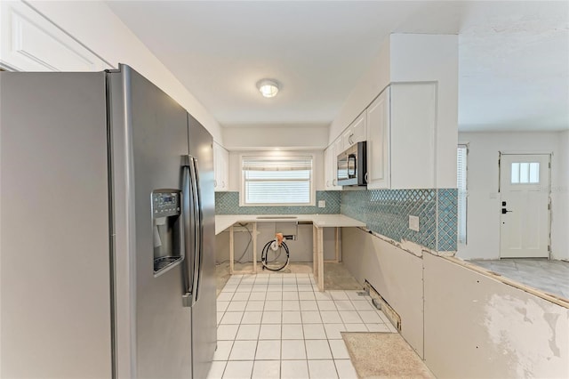3304 7th Street Ct W, Palmetto, FL 34221 - kitchen featuring appliances with stainless steel finishes, tasteful backsplash, white cabinets, and healthy amount of natural light