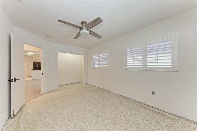 3304 7th Street Ct W, Palmetto, FL 34221 - unfurnished bedroom with speckle patterned floor, a closet, a ceiling fan, and refrigerator with ice dispenser