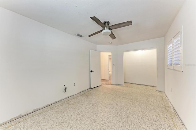3304 7th Street Ct W, Palmetto, FL 34221 - unfurnished bedroom with dark speckled floor, a ceiling fan, and a closet
