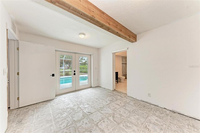 3304 7th Street Ct W, Palmetto, FL 34221 - spare room with beamed ceiling and french doors